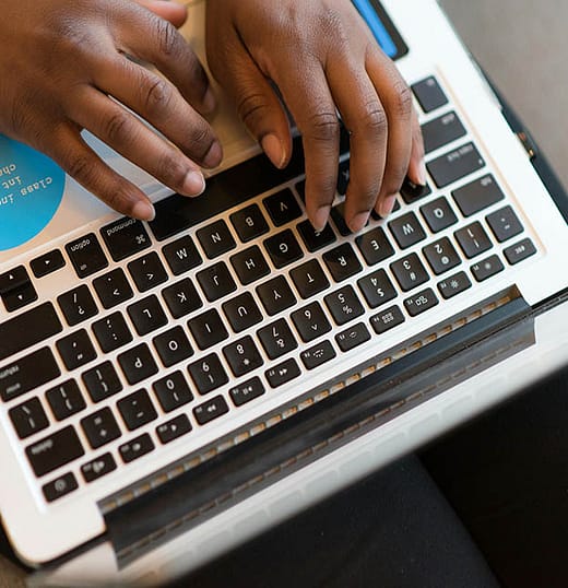black hands depicting a product manager working on a computer